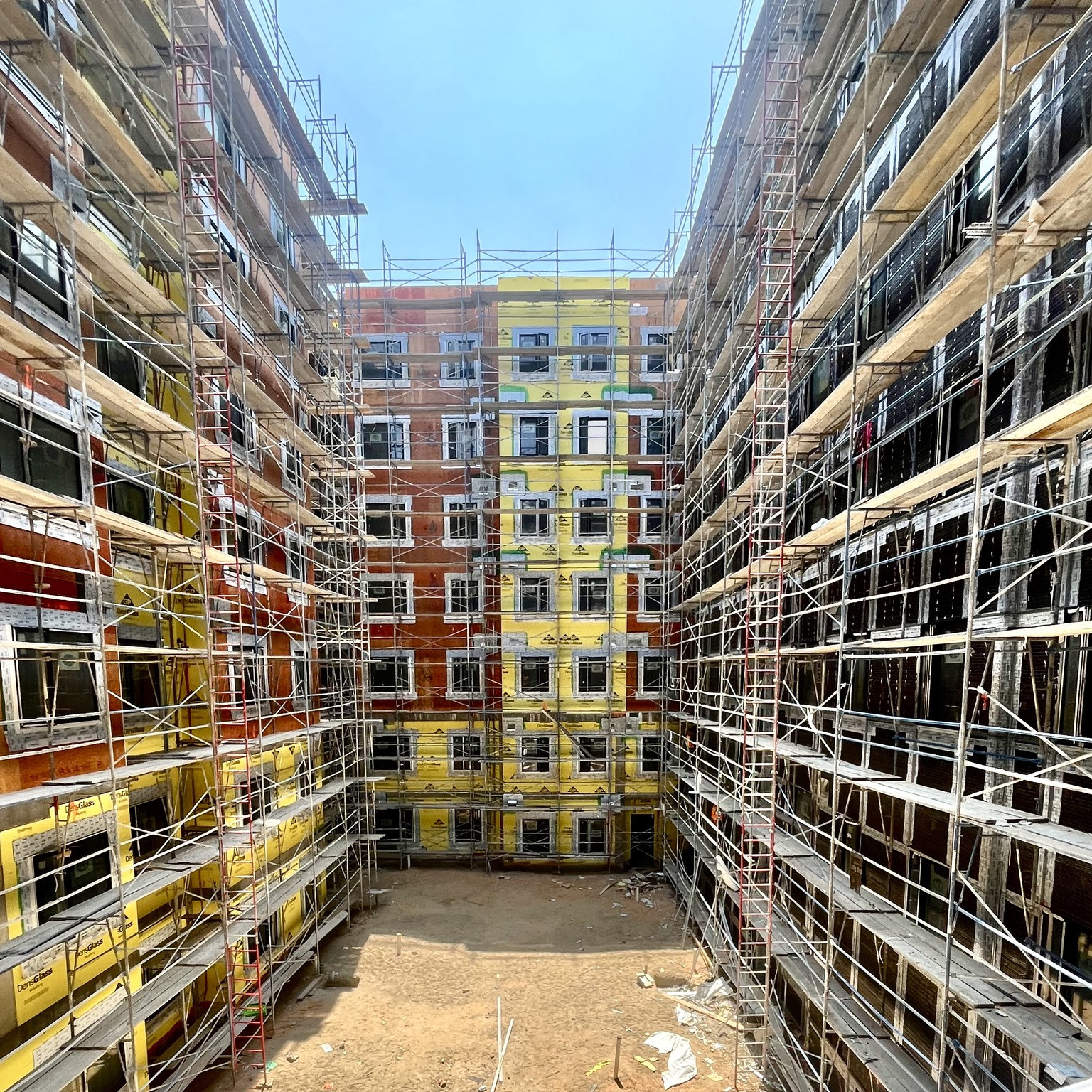 Multifamily construction progress courtyard and scaffolding